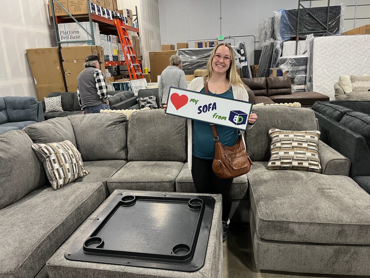BoxDrop North Idaho customer Hallie with her new sectional and ottoman